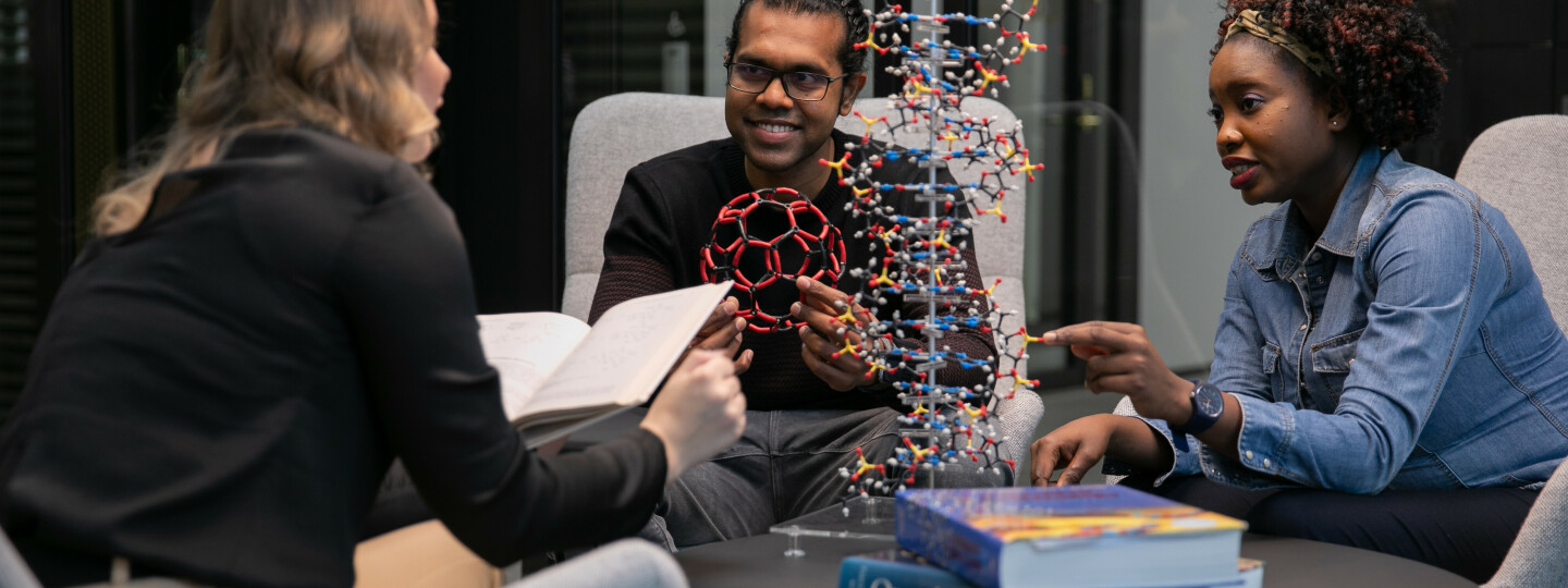 Students discussing over a a molecular building block