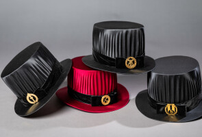 Four doctoral hats, one red, the other three black.