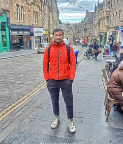 A photo of Prince Adhikary standing on a street in a city.