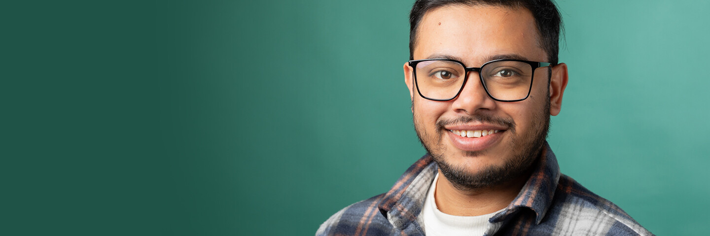 A person smiling on the right side of the picture