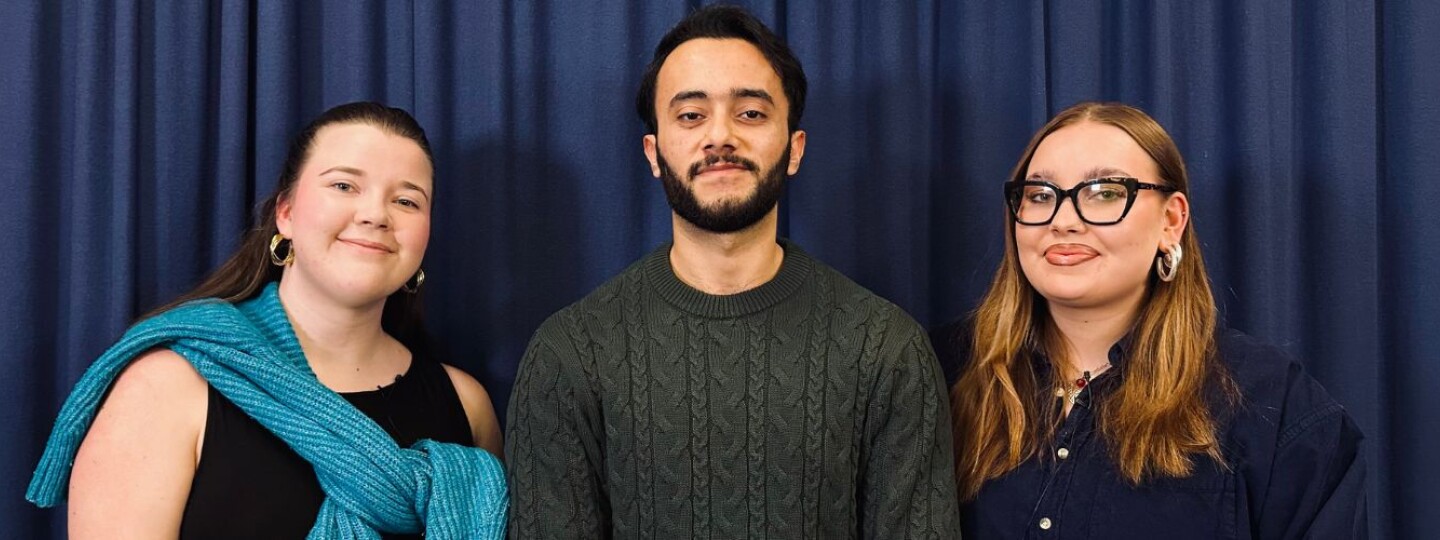 Three people standing next to each other