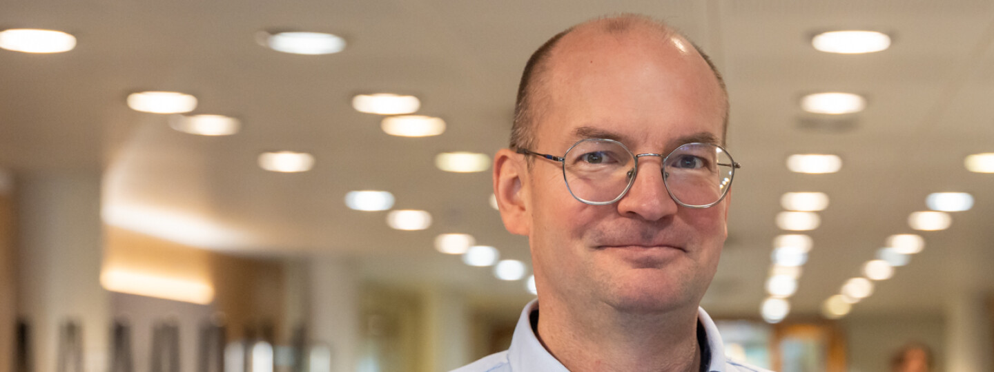 Photo of Jouni Jokinen in a pale blue shirt looking at the camera