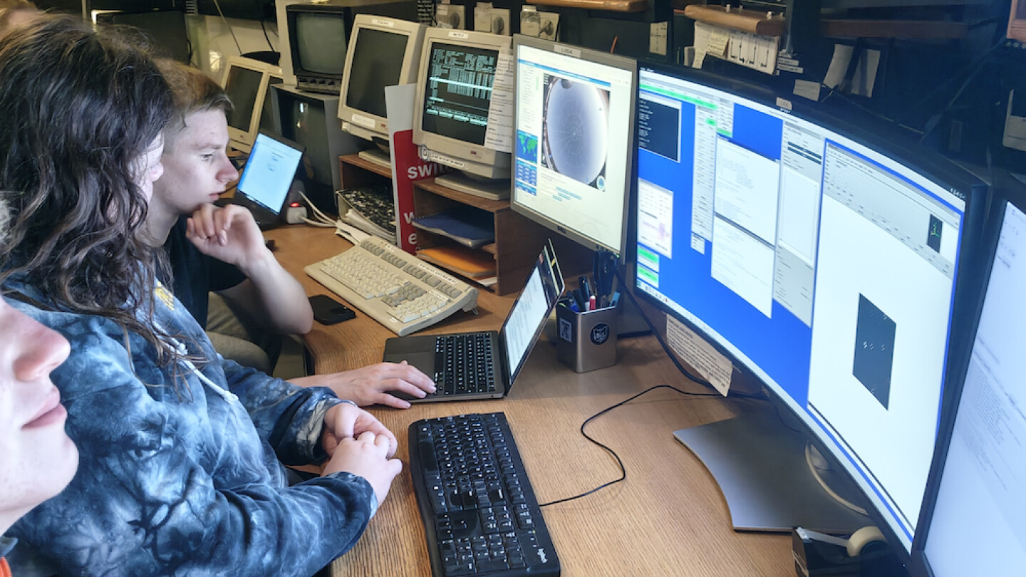 NOT-koululaisia ohjaamassa kaukoputkea tietokoneen välitykseltä