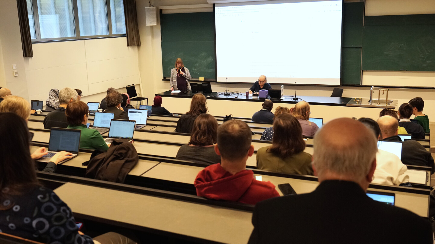 People in a lecture hall listening to a presentation
