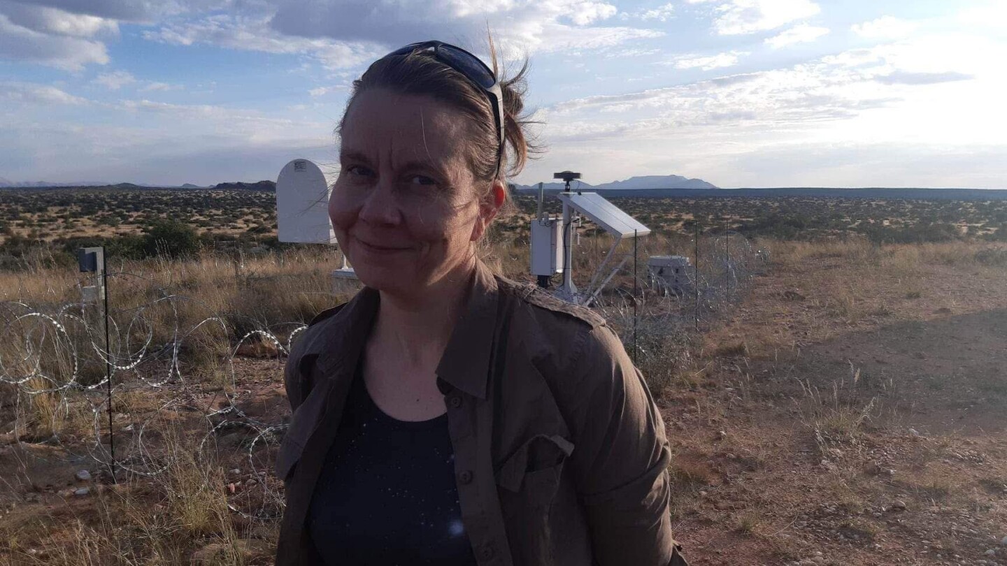 Ihminen seisoo ulkona tasaisessa kuivan näköisessä maastossa.