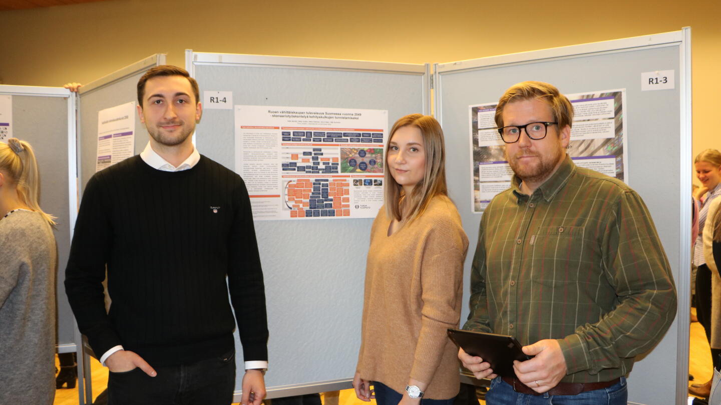 Opiskelijat Ruoan vähittäiskaupan tulevaisuus Suomessa vuonna 2049 -posterin ympärillä