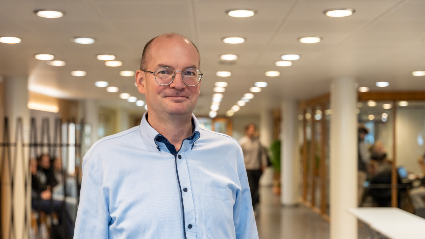 Photo of Jouni Jokinen in a pale blue shirt looking at the camera
