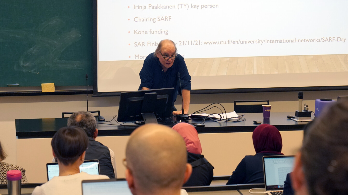 Martin Cloonan giving a presentation in front of an audience.