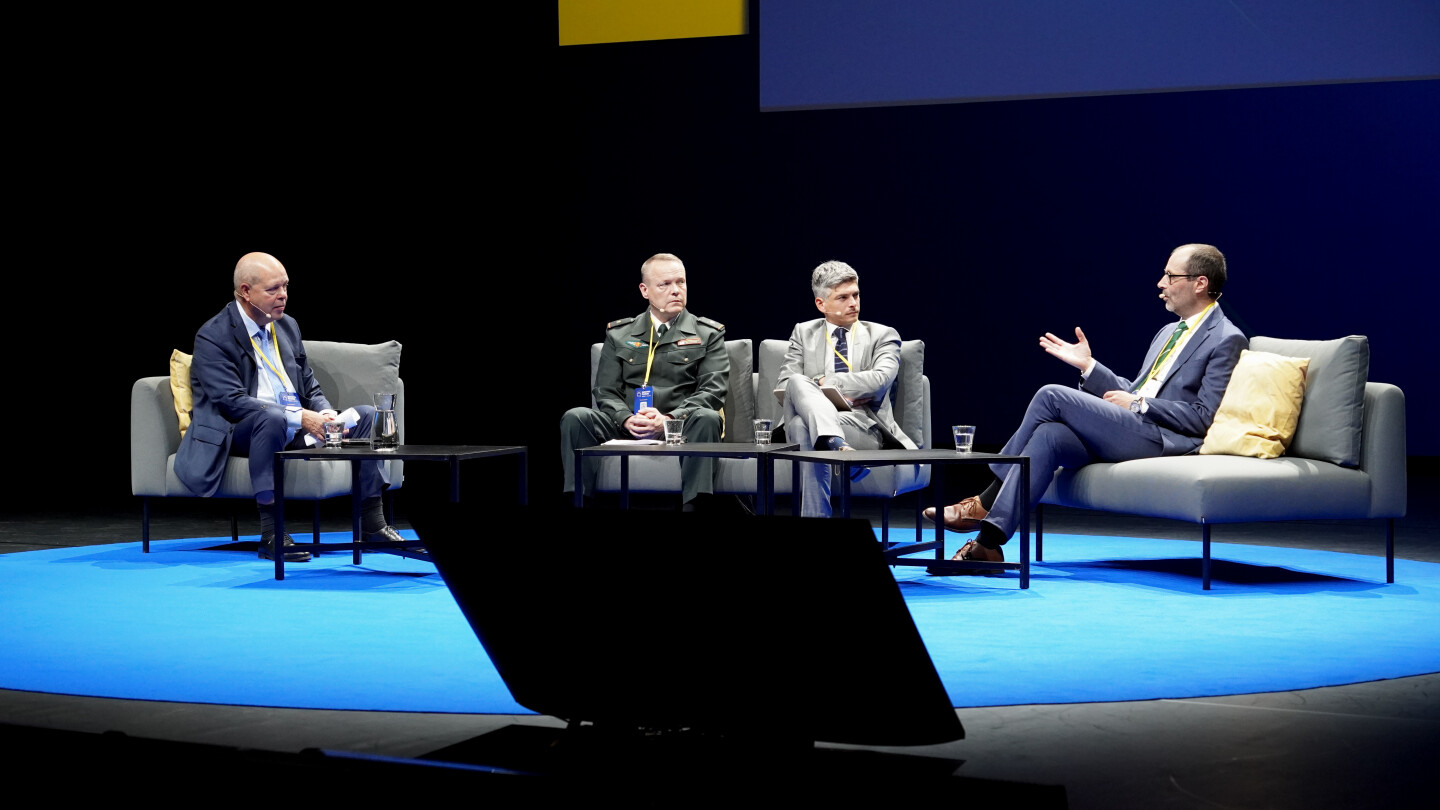 four panellists sitting on a stage
