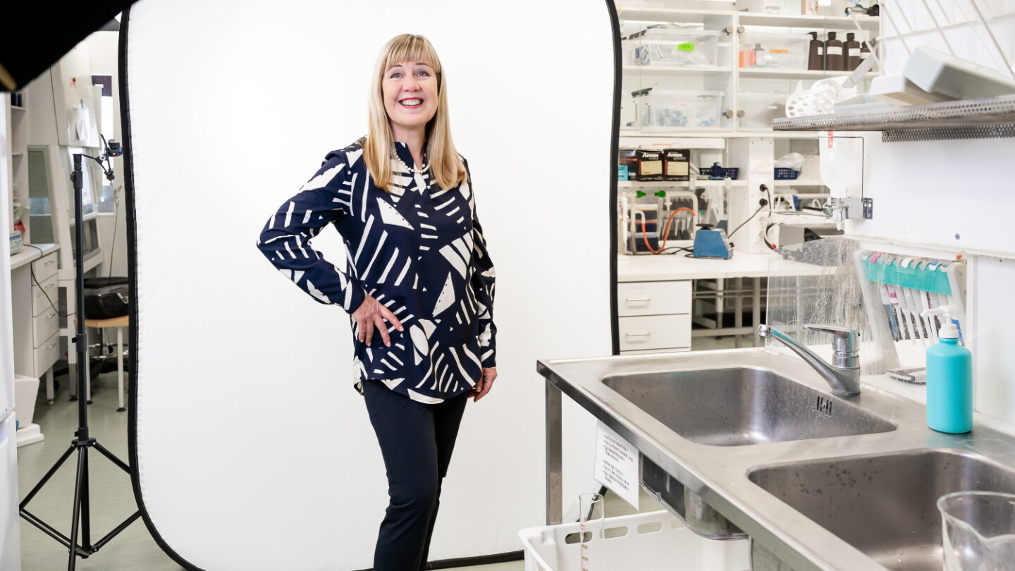 Riitta Lahesmaa standing in a laboratory and looking at the camera