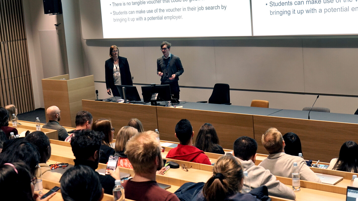 two people addressing the audience