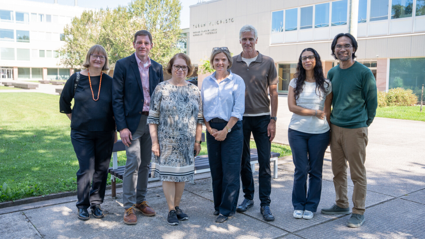 seven people standing together looking at the camera