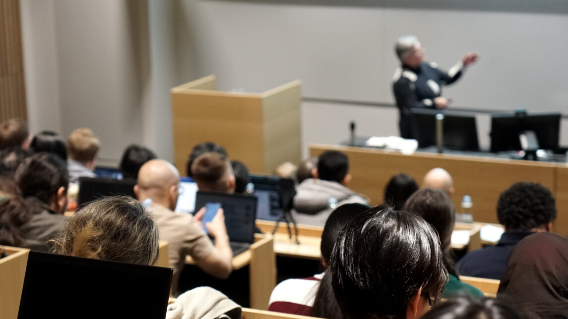 Audience listening to a speaker in an auditorium