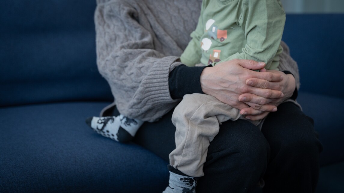 Pieni lapsi aikuisen sylissä