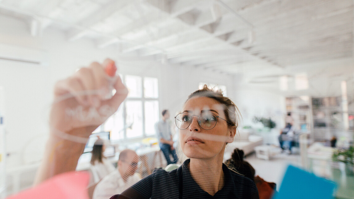 Woman writing on a glass