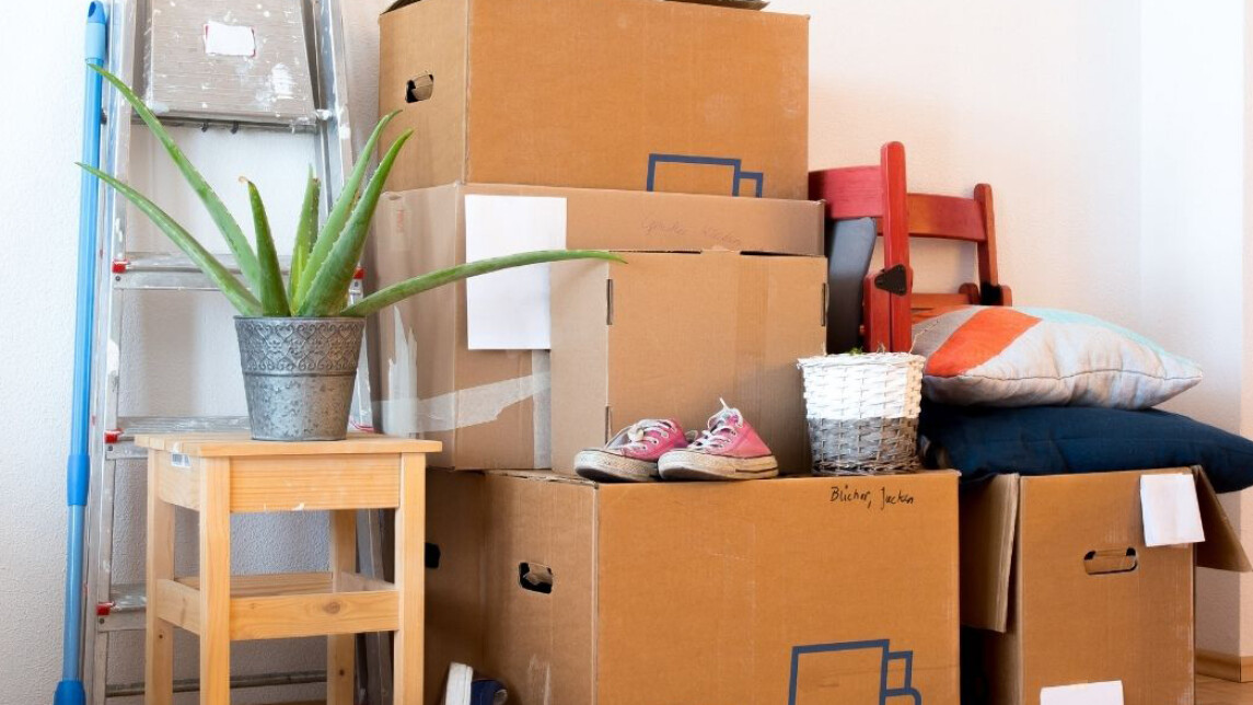 muuttolaatikoita kasattuna seinän viereen