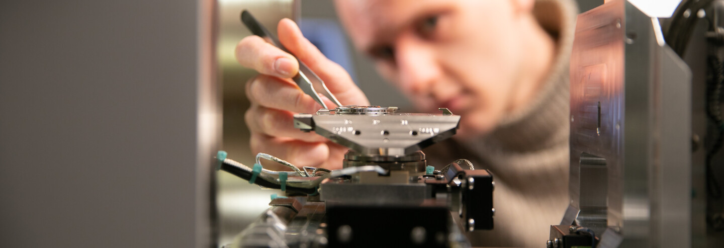 A researcher working with measuring equipment