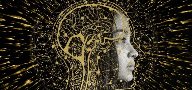 Kuvituskuva, jossa henkilön sivuprofiilin päälle on piirretty aivojen ja hermoston ääriviivat. Taustalla kullanvärisiä kipinöitä. 