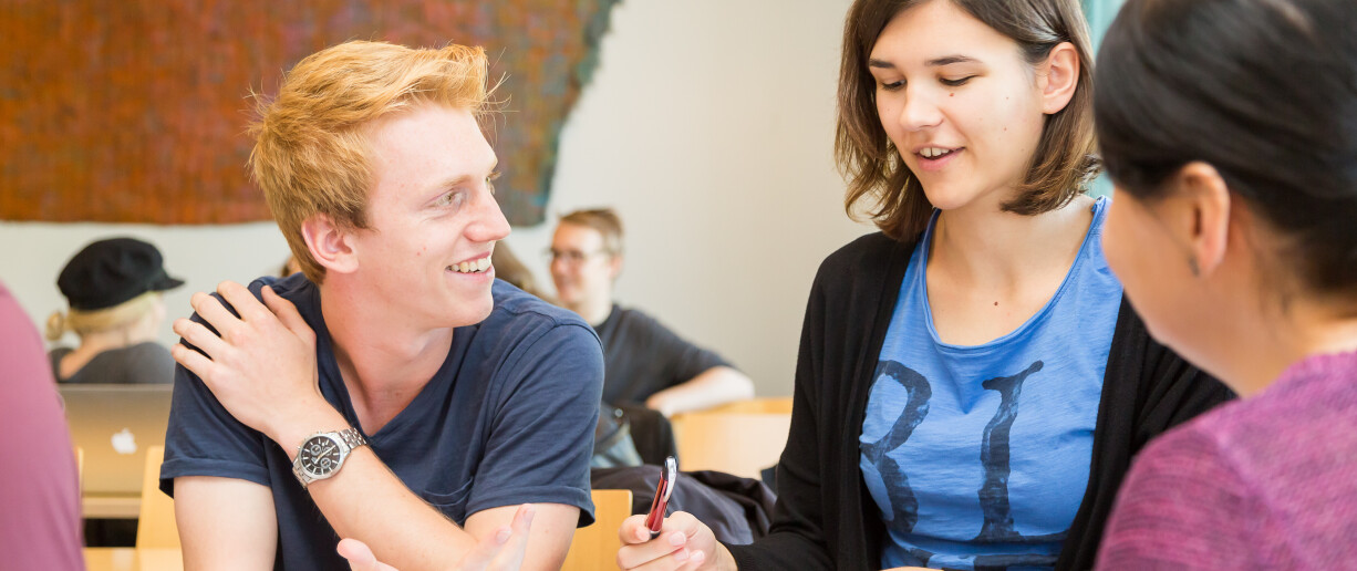 three people sitting together studying