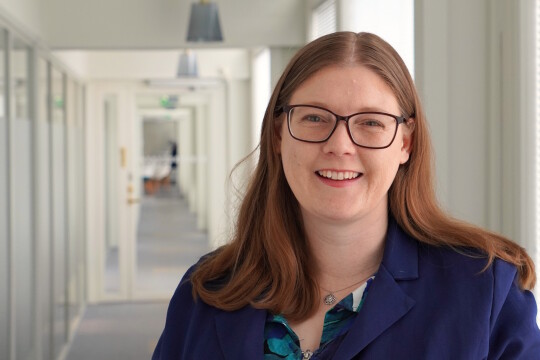 Anna Scheer smiling in a hallway