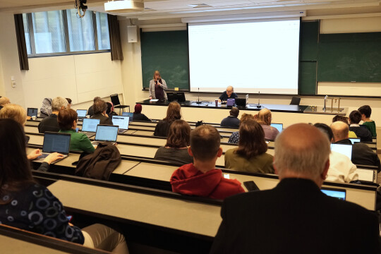 People in a lecture hall listening to a presentation