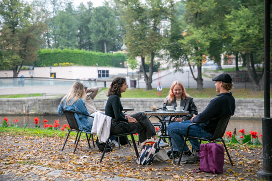 Four studends sitting outside having coffee