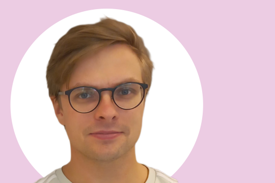Hans Bergman lähikuvassa, taustalla vaaleanpunaista ja valkoista.