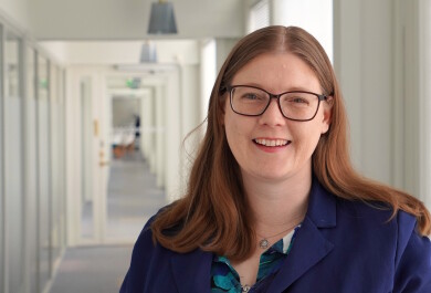Anna Scheer smiling in a hallway