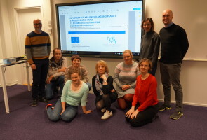 A group of teachers in front of a screen