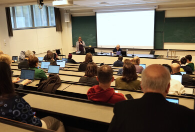 People in a lecture hall listening to a presentation