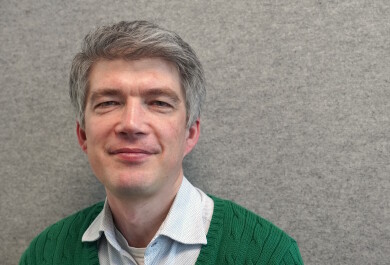 David Molnar closeup in front of a gray wall