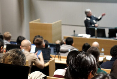 Audience listening to a speaker in an auditorium