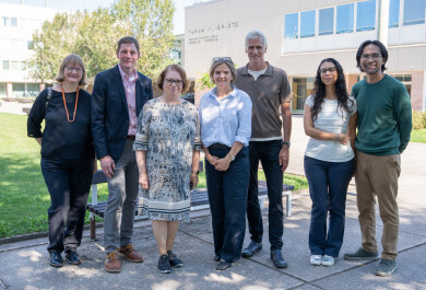 seven people standing together looking at the camera