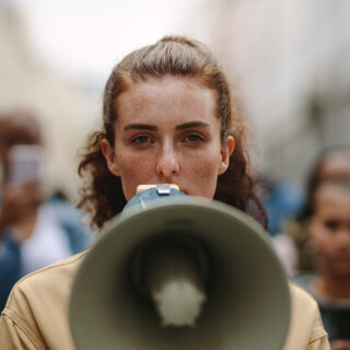 Activist protesting with megaphone during a strike