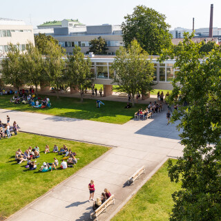 Turun Yliopistonmäki kuvattuna ylhäältäpäin niin, että suihkulähde ja Natura-rakennus näkyvät, kuvassa uusia opiskelijoita